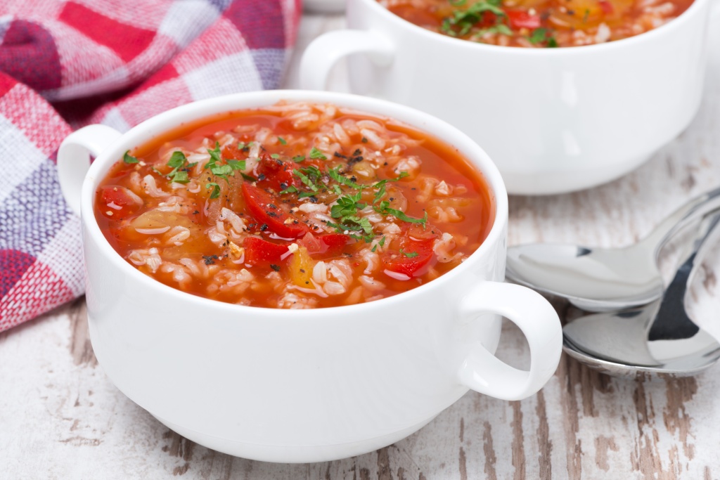 tomato soup with rice and vegetables in a bowl